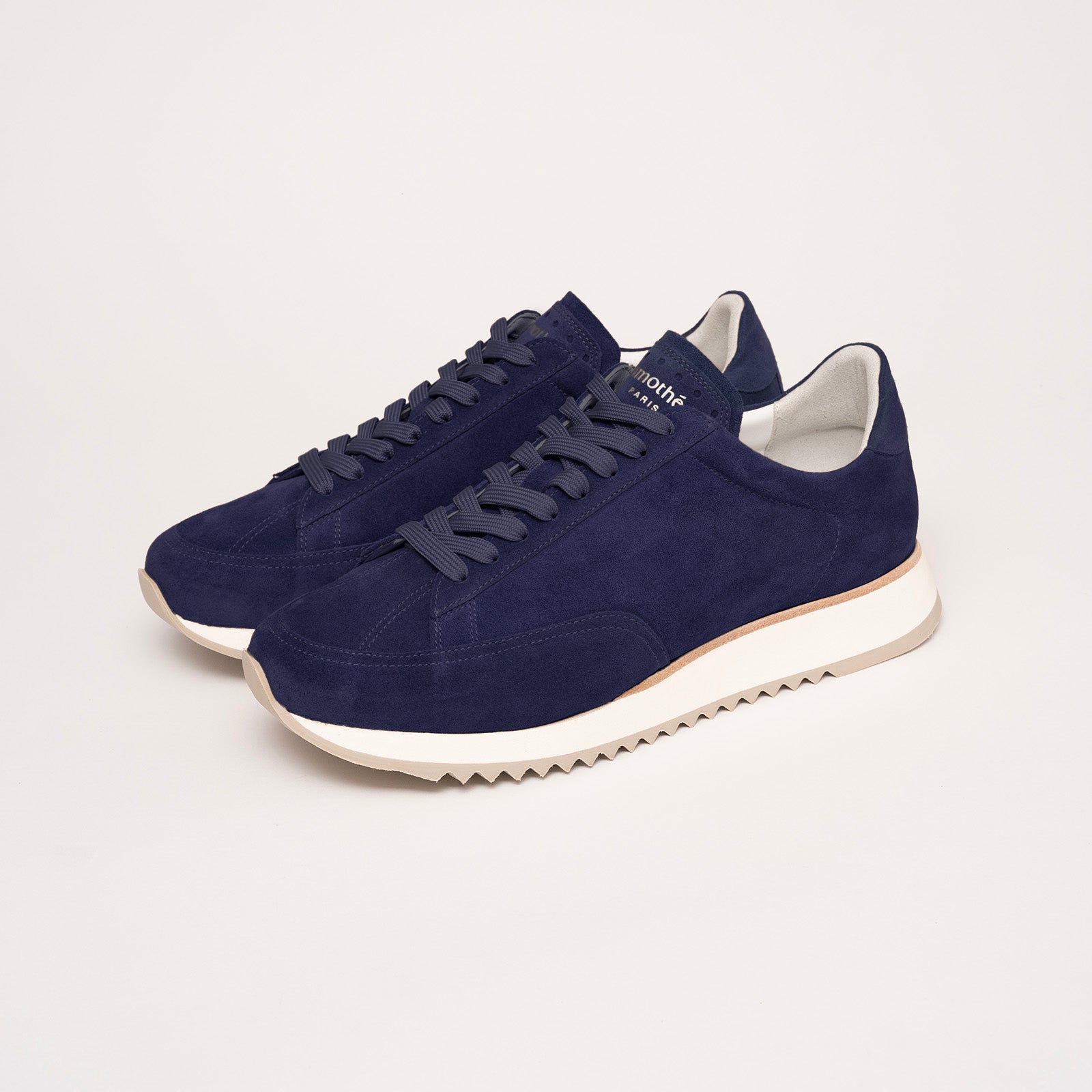 Quarter view of the Cabourg sneaker in navy blue by Timothée Paris, showcasing supple handcrafted leather and refined minimalist construction.