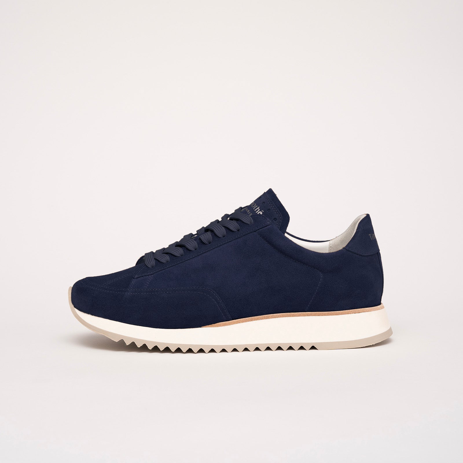 Profile view of the Cabourg sneaker in navy blue by Timothée Paris, showcasing supple handcrafted leather and refined minimalist construction.