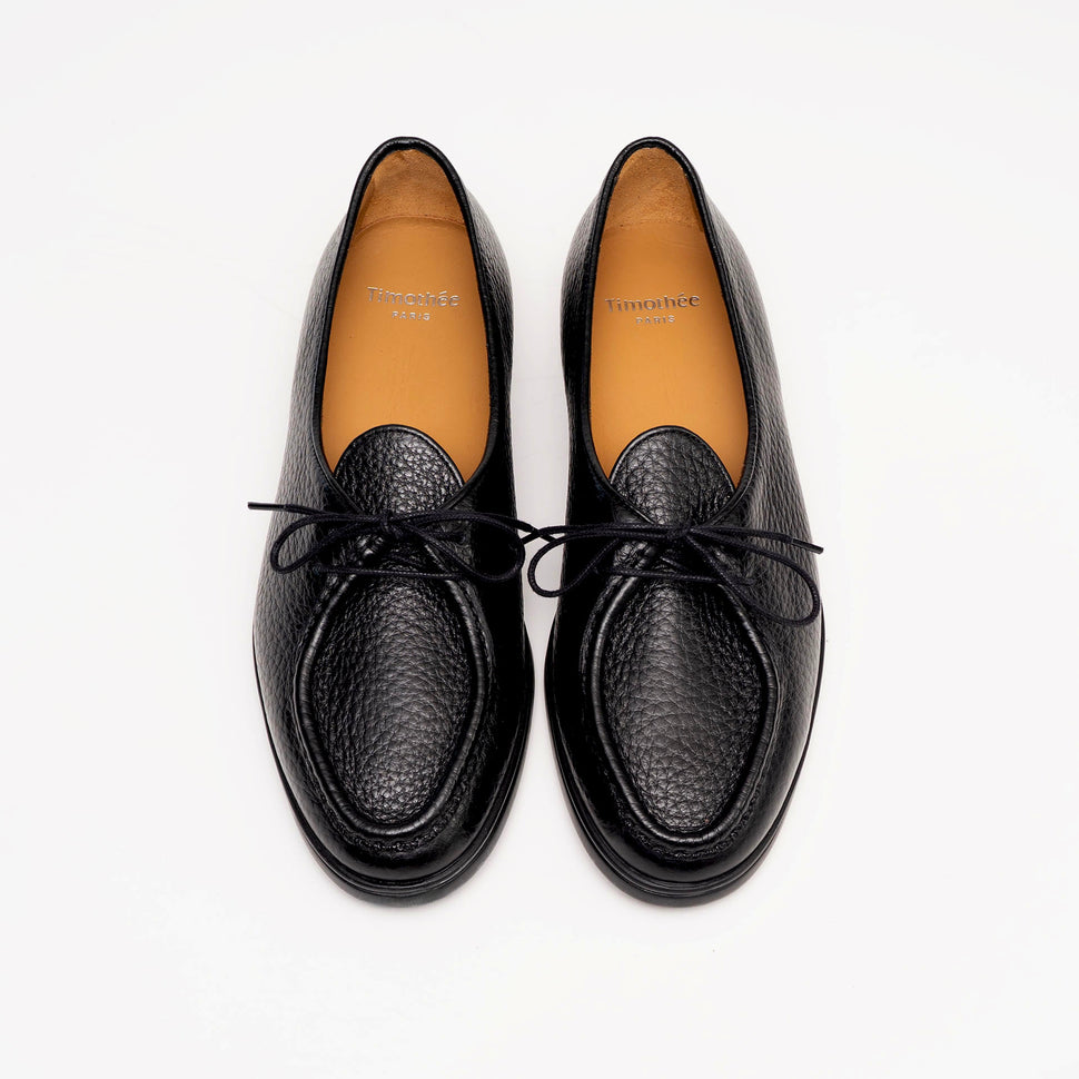 Top view of Beaune lace-up loafers in luxurious black pebbled leather by Timothée Paris, highlighting soft leather lining and minimalist detailing.