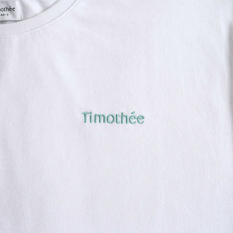white-short-sleeve-embroidered-timothee-paris-logo-on-chest-oversized-tshirt-close-up-mint-green