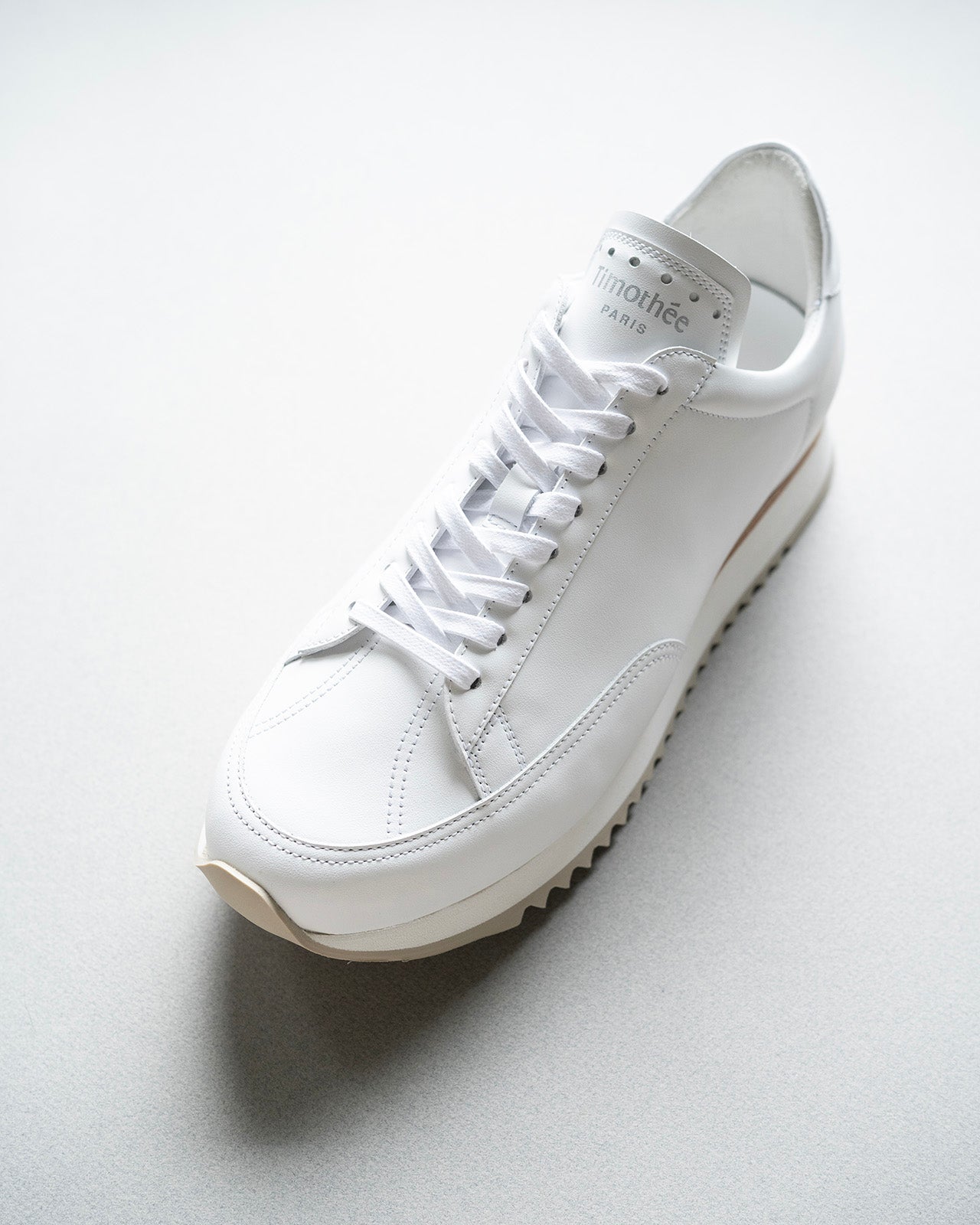 French brand Timothee Paris sneaker cabourg white still life photo from quarter top