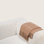 brown alpaca blanket by french-lifestyle brand timothee paris on a white sofa