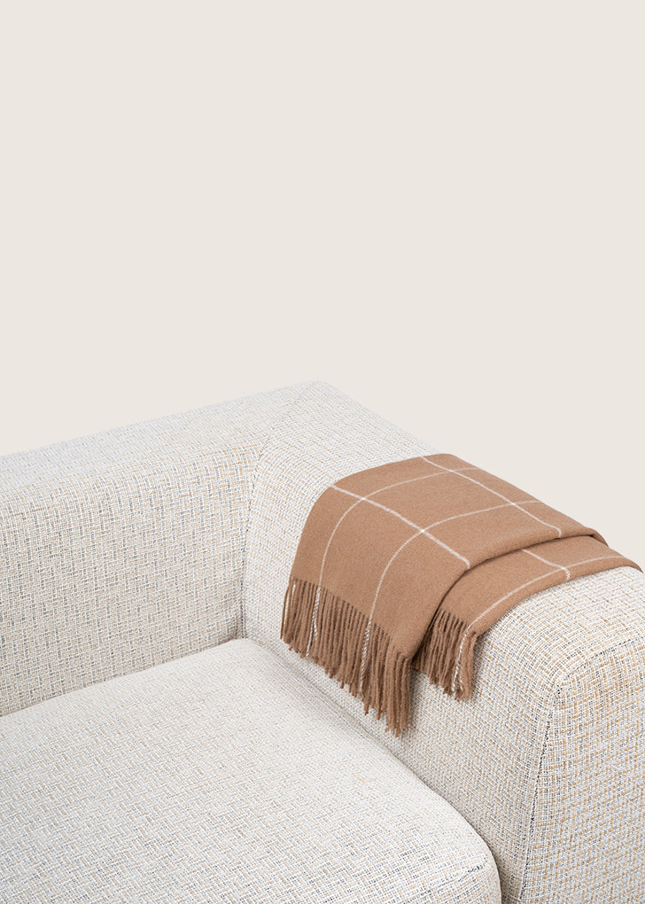 brown alpaca blanket by french-lifestyle brand timothee paris on a white sofa
