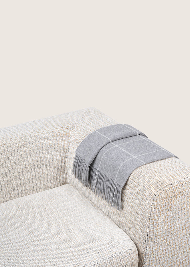 light-grey alpaca blanket by french-lifestyle brand timothee paris on a sofa