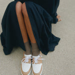 bi-coour french clean sneaker pyla worn with black dress Timothee Paris