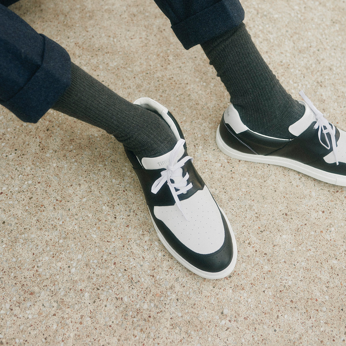 hand crafted sneaker pyla by timothee paris worn with navy trousers by a model