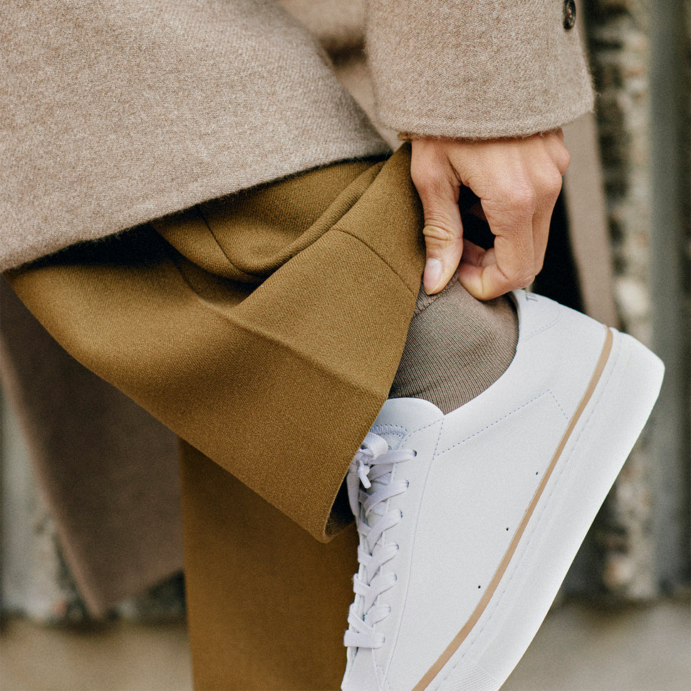 French handcrafted clean white sneaker Atlantique by timothee paris worn with mustard trousers