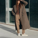 timothee paris sneaker atlantique stone beige worn by a woman with a long coat