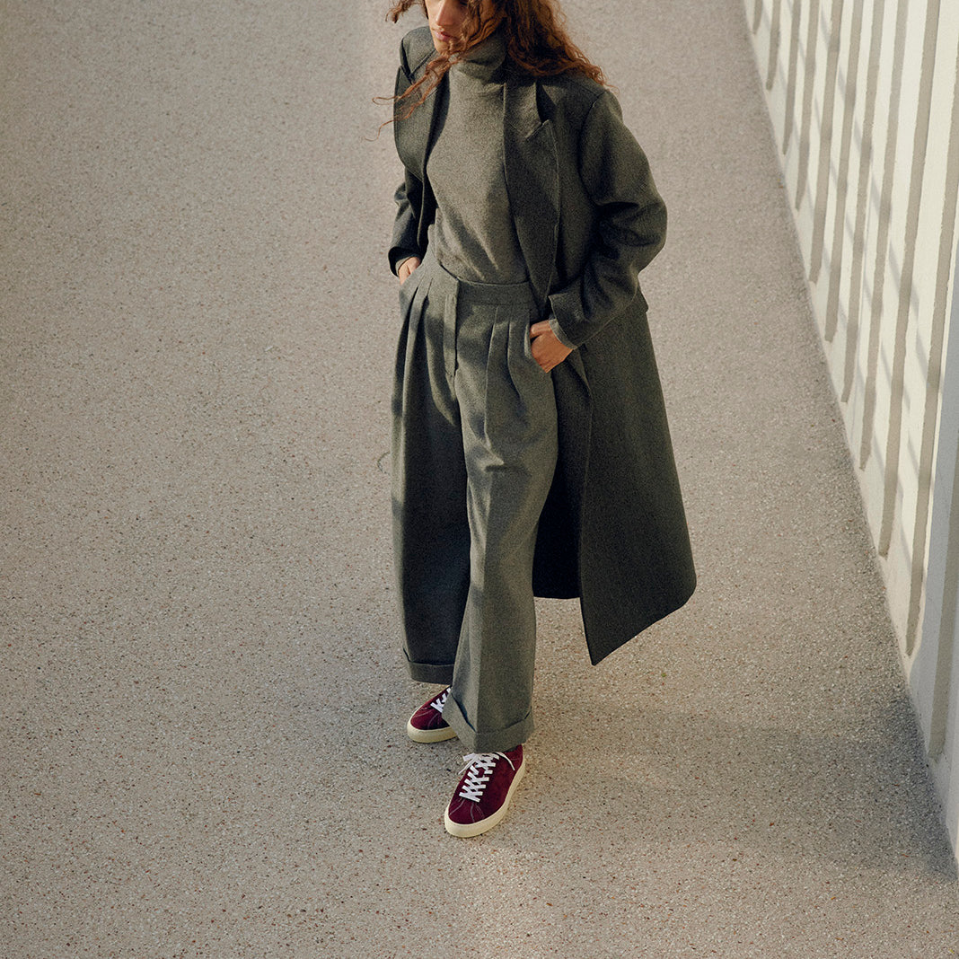 Timothee paris sneaker Atlantique sustainable suede mahogany red worn with grey trousers