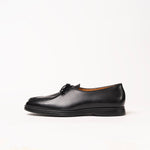Black leather loafer-style shoe with a moc-toe seam and black laces by Timothée Paris, shown in profile against a clean white background.