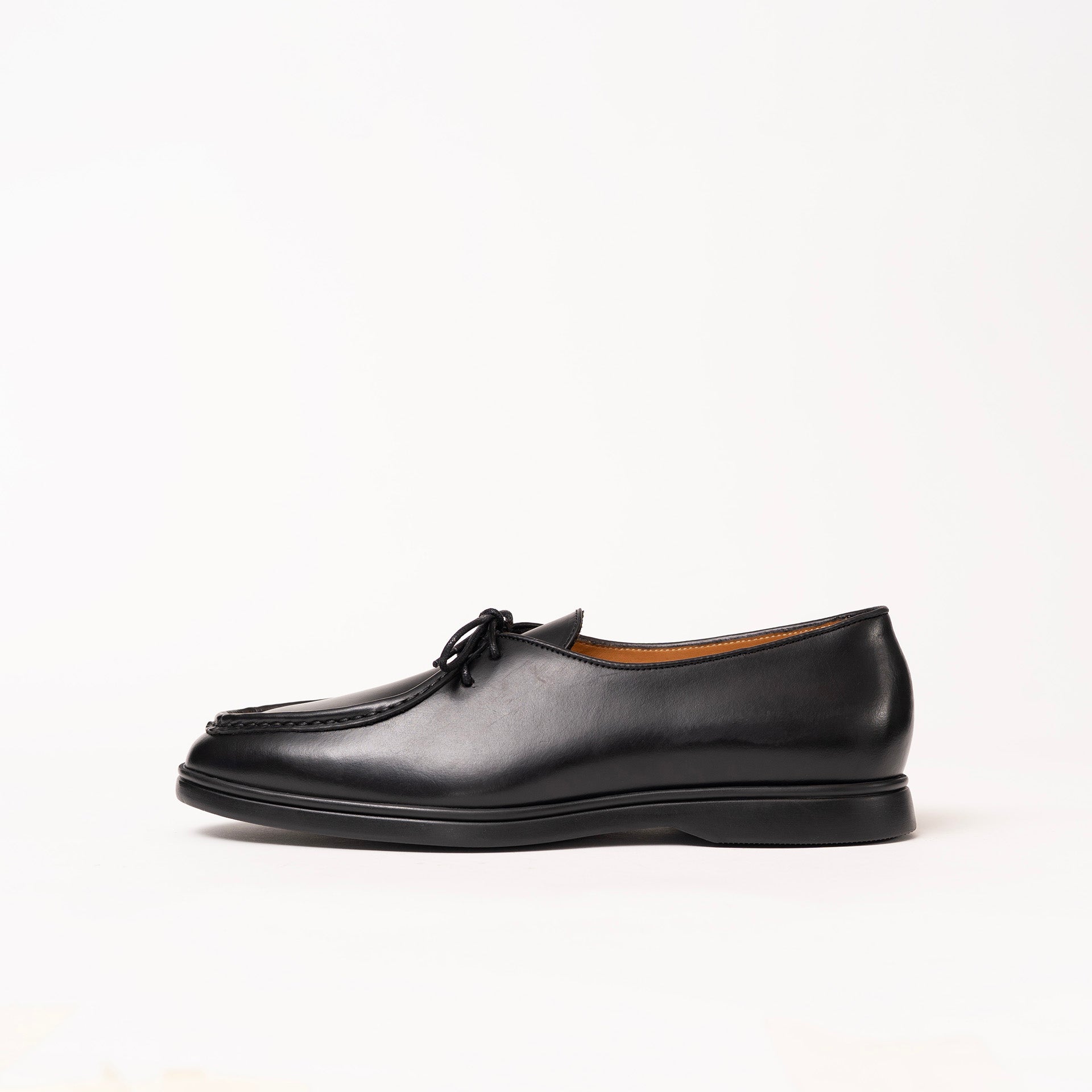 Black leather loafer-style shoe with a moc-toe seam and black laces by Timothée Paris, shown in profile against a clean white background.