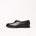 Black leather loafer-style shoe with a moc-toe seam and black laces by Timothée Paris, shown in profile against a clean white background.
