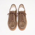Pair of brown suede and leather sneakers with latex sole by Timothée Paris on a light gray background