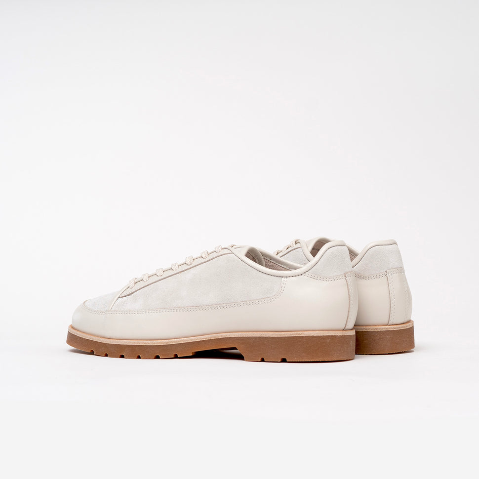 Pair of white Timothee Paris sneakers on a white background