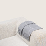light-grey alpaca blanket by french-lifestyle brand timothee paris on a sofa