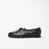 Side view of Beaune loafers in black pebbled leather by Timothée Paris, emphasizing its clean silhouette and subtle refinement