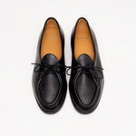 Top view of Beaune lace-up loafers in luxurious black pebbled leather by Timothée Paris, highlighting soft leather lining and minimalist detailing.