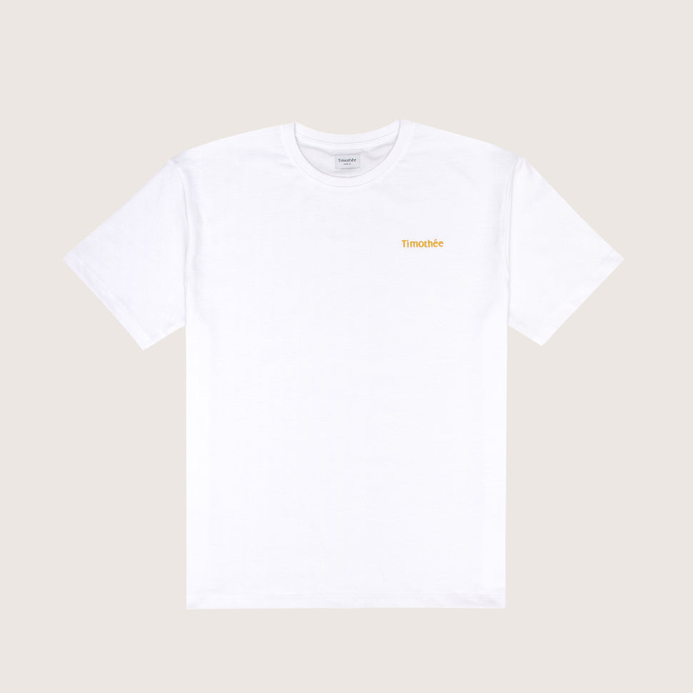 white-short-sleeve-embroidered-timothee-paris-logo-on-chest-oversized-tshirt-front-view-honey-gold